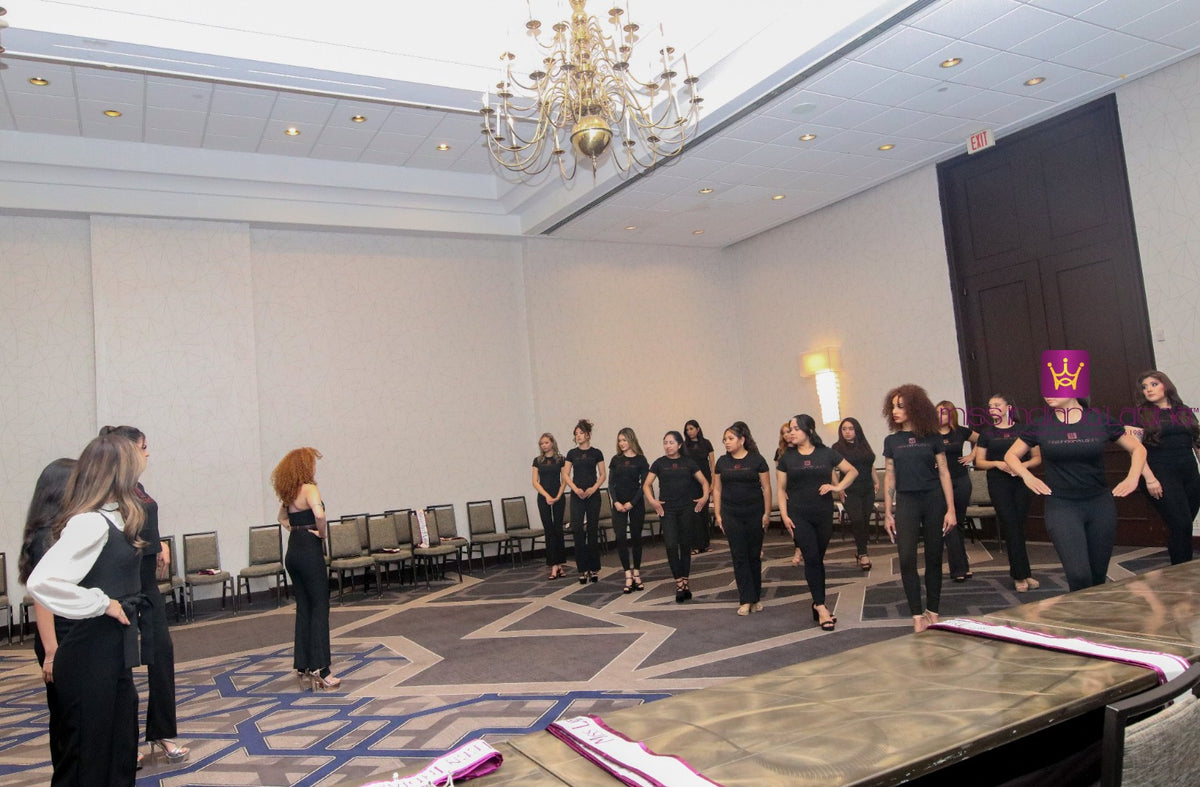 Participants practicing runway poses during a modeling rehearsal